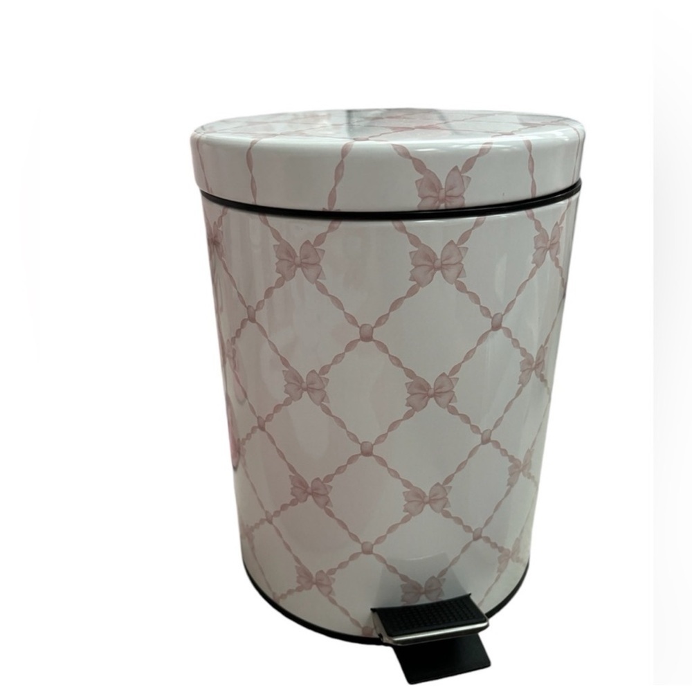 Small white garbage can with pink bows